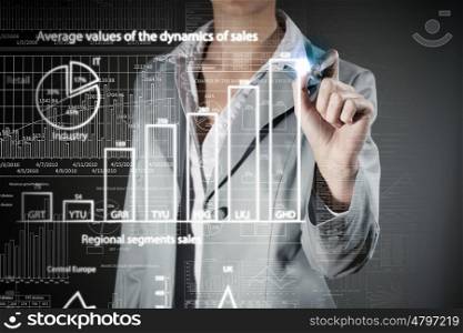 Avarage sales dynamics. Chest view of businesswoman drawing infographs on digital screen