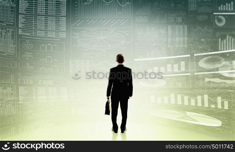 Average sales report. Rear view of businessman with suitcase and infographs on virtual panel