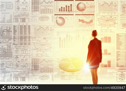 Average sales report. Rear view of businesswoman with suitcase and infographs on virtual panel