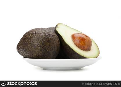 avocado fruit in ceramic plate isolated on white background with clipping path and soft shadow