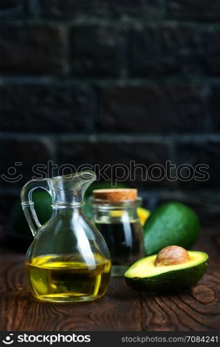 avocado oil in bottle and on a table