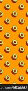 Avocado on orange background pattern top view flat lay. Summer color. Minimal concept. Avocado on orange background pattern top view flat lay