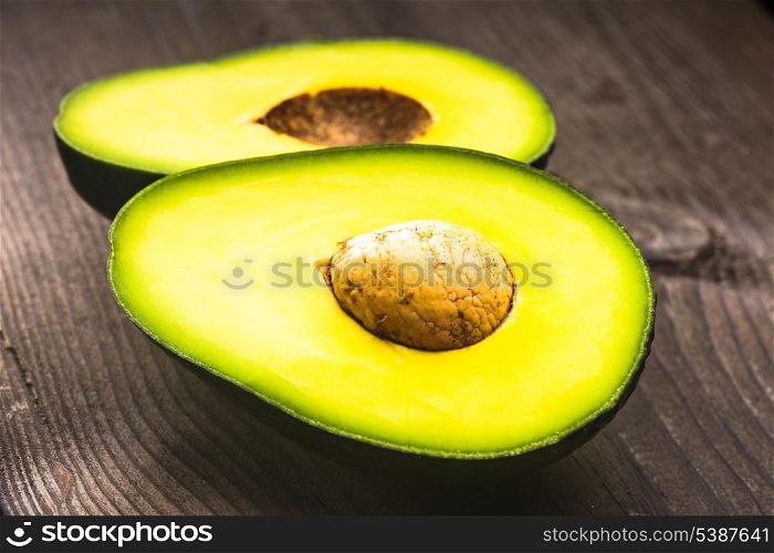 Avocado on the wooden table colse up