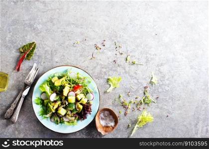 Avocado salad with cucumber and other vegetables on a plate. Avocado salad with cucumber and other vegetables in a blue vintage bowl