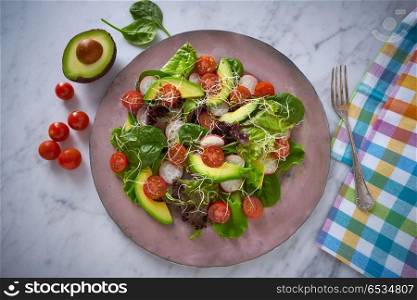 Avocado salad with sprouts tomatoes spinach. Avocado salad with sprouts tomatoes spinach and radish healthy food