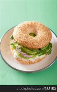 avocado sandwich on bagel with cream cheese onion cucumber arugula