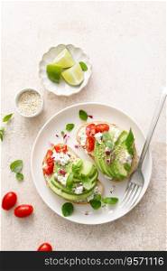 Avocado toast with cheese cottage, tomato and herbs for breakfast
