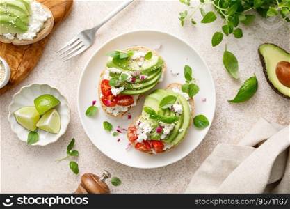 Avocado toast with cheese cottage, tomato and herbs for breakfast