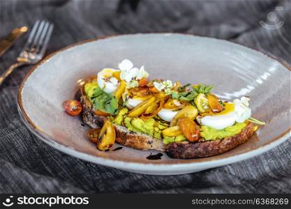 Avocado toast with cherry tomatoes and eggs