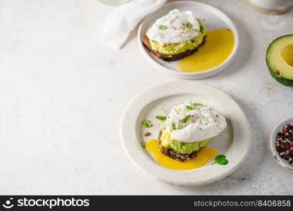 Avocado toast with poached egg on white background. Healthy Breakfast concept.. Avocado toast with poached egg