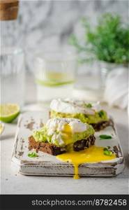 Avocado toast with poached egg on white background. Healthy Breakfast concept.. Avocado toast with poached egg
