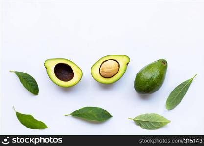 Avocado with green leaves on a white background.