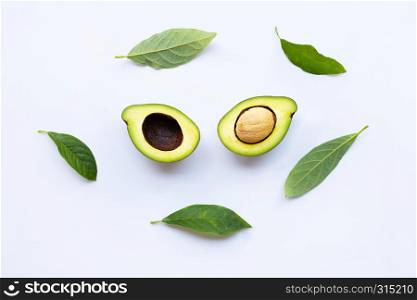 Avocado with green leaves on a white background.