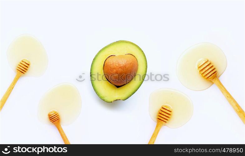 Avocado with honey on white background. Top view