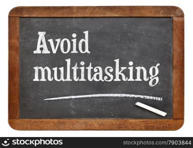 Avoid multitasking advice on a vintage slate blackboard