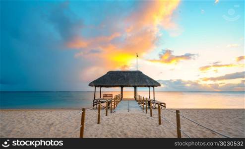 Awesome sunset at mauritius. Amazing sunset in Mauritius Island (flic an flac beach) with Jetty silhouette.