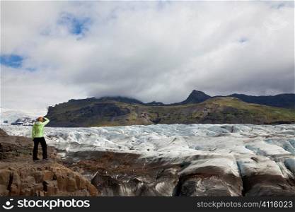 Awoman hiker looking out on the Vatnajokull Glacier, Iceland