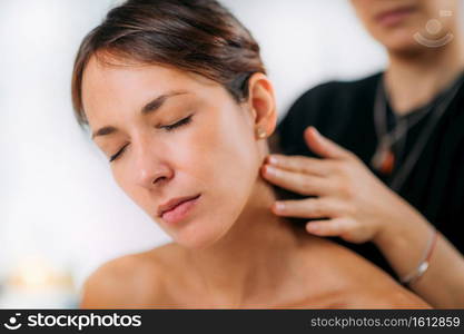 Ayurvedic Practitioner Massaging Female Client Neck with Ethereal Ayurveda Oil 