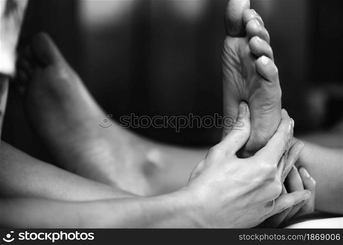 Ayurvedic Reflexology Foot Massage, Ayurveda practitioner pressing meridian points on female foot.. Ayurvedic Reflexology Foot Massage