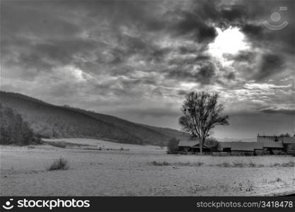 B/W photo of dramatic sky, and sun rays through the clouds