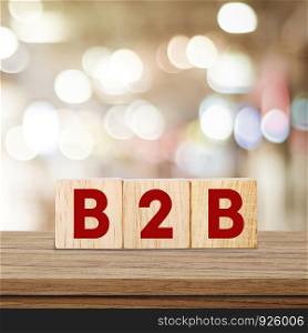 B2B , business to business marketing, on wooden cubes over blur background, banner