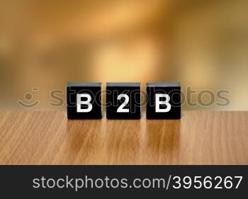 B2B or business to business on black block with blurred background