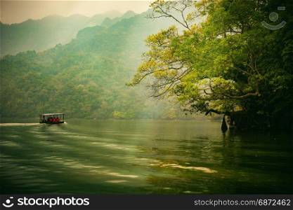 Ba Be lake, Bac Kan province, Vietnam - September 22, 2016 : tourists on the boat are going to enjoy and explore Ba Be lake. Stunning scenery of Ba Be Lake in Bac Kan Province, Vietnam