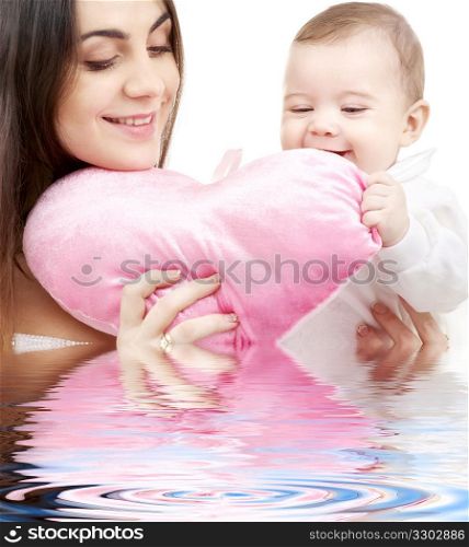 baby and mama with heart-shaped pillow