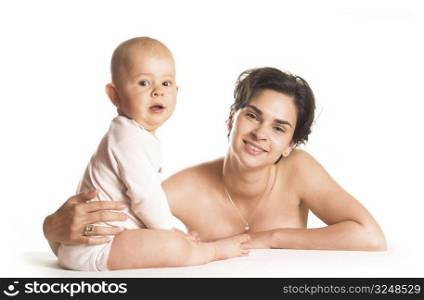 Baby and mother are playing together in front of a white background.
