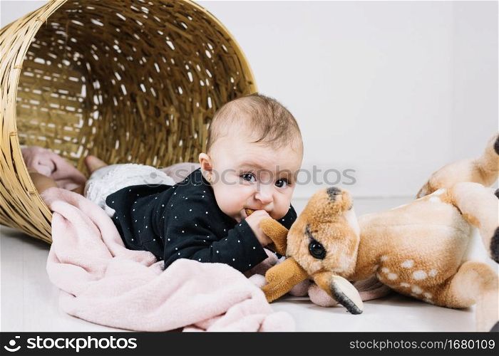 baby biting toy looking camera