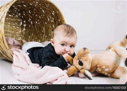 baby biting toy looking camera
