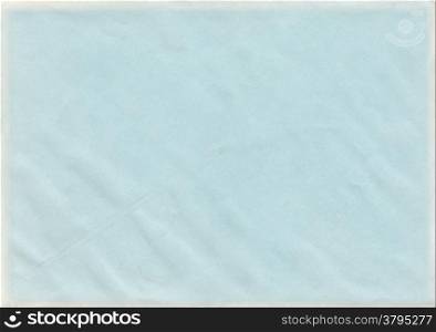 Baby blue color vintage paper with wrinkles and marks and a yellowed edge