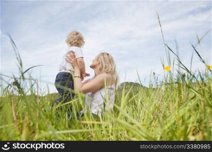 Baby boy and young mother looking at a view