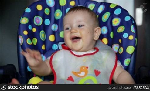 Baby boy at lunch time laughing, with sound