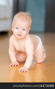 Baby boy crawling on floor