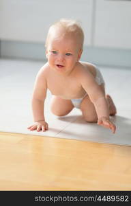 Baby boy crawling on floor