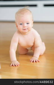 Baby boy crawling on floor