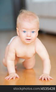 Baby boy crawling on floor