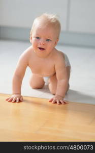 Baby boy crawling on floor