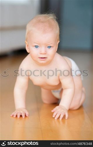 Baby boy crawling on floor