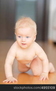 Baby boy crawling on floor