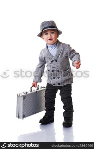 Baby boy holding silver suitcase.