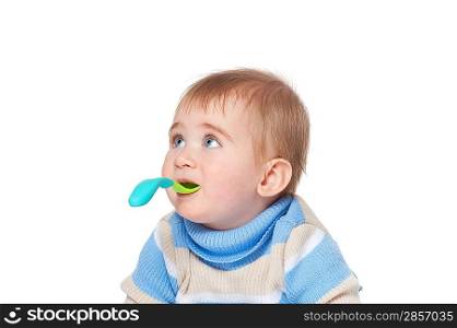 Baby boy holding spoon in his mouth