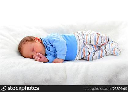 Baby boy in sleeping on bed