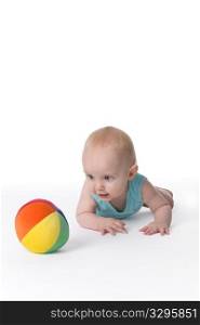 Baby Boy Is Crawling Towards A Colored Toy Ball