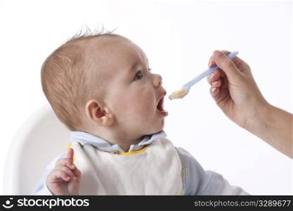 Baby Boy Is Fed With A Spoon