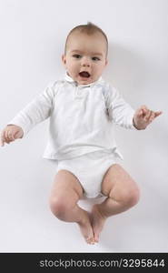 Baby Boy Is Lying On His Back The Floor On White Background