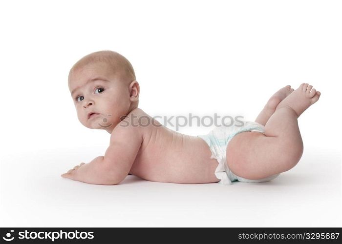 Baby boy lying on his belly full lenght on white background
