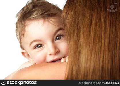 Baby boy playing peek-a-boo, cute little child looks out of his mother's shoulder, isolated on white background, happy family having fun