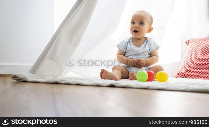 Baby Boy Sitting In Tent And Playing With Toys At Home